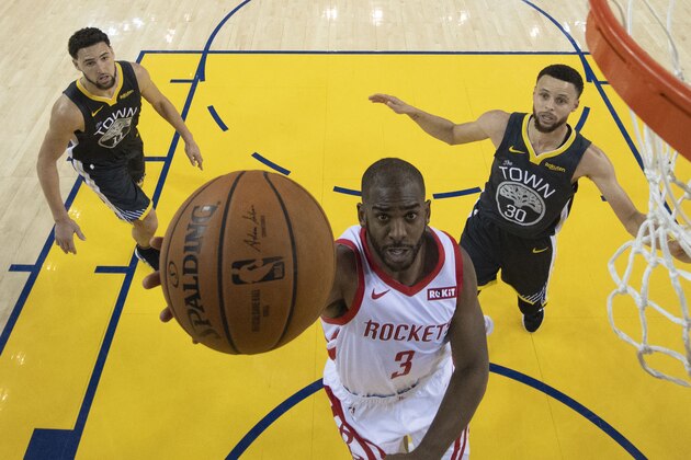 Houston Rockets guard Chris Paul (3) shoots in front of Golden State Warriors guard Klay Thompson (11) and guard Stephen Curry (30) during the second half of Game 2 of a second-round NBA basketball playoff series in Oakland, Calif., Tuesday, April 30, 2019. (Kyle Terada/Pool Photo via AP)
