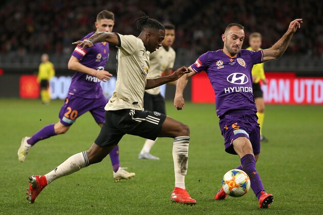 PERTH, AUSTRALIA - JULY 13: Aaron Wan-Bissaka of Manchester United is challenged by Ivan Franjic of the Glory during the match between the Perth Glory and Manchester United at Optus Stadium on July 13, 2019 in Perth, Australia. (Photo by Paul Kane/Getty Images)