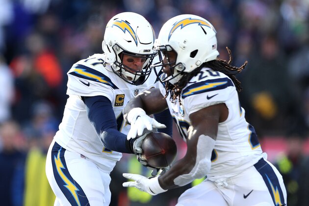FOXBOROUGH, MASSACHUSETTS - JANUARY 13: Philip Rivers #17 of the Los Angeles Chargers hands off the ball to Melvin Gordon #28  during the second quarter in the AFC Divisional Playoff Game against the New England Patriots at Gillette Stadium on January 13, 2019 in Foxborough, Massachusetts. (Photo by Adam Glanzman/Getty Images)