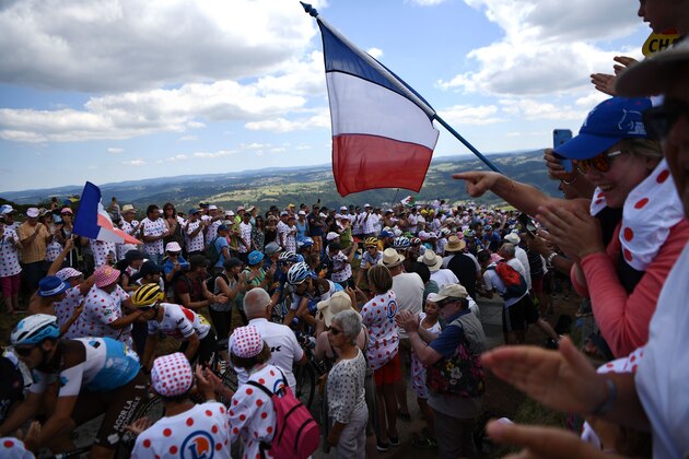TOPSHOT - Cyclism enthusiasts cheer riders of the pack in the Mur d'Aurec-sur-Loire during the ninth stage of the 106th edition of the Tour de France cycling race between Saint-Etienne and Brioude, on July 14, 2019. (Photo by Anne-Christine POUJOULAT / AFP)        (Photo credit should read ANNE-CHRISTINE POUJOULAT/AFP/Getty Images)