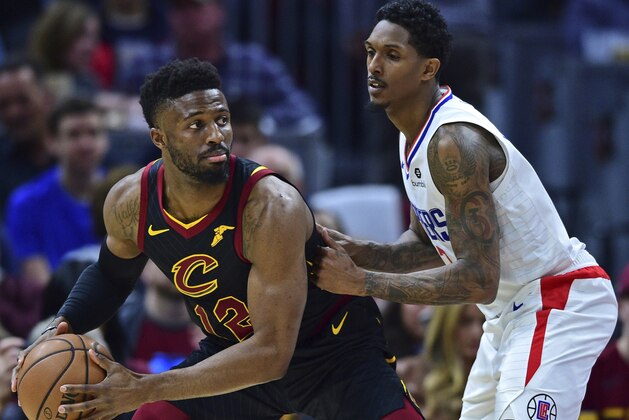 Cleveland Cavaliers guard David Nwaba drives on Los Angeles Clippers guard Lou Williams in the first half of an NBA basketball game, Friday, March 22, 2019, in Cleveland. The Clippers won 110-108. (AP Photo/David Dermer)
