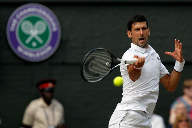 Serbia's Novak Djokovic returns against Switzerland's Roger Federer during their men's singles final on day thirteen of the 2019 Wimbledon Championships at The All England Lawn Tennis Club in Wimbledon, southwest London, on July 14, 2019. (Photo by Adrian DENNIS / POOL / AFP) / RESTRICTED TO EDITORIAL USE        (Photo credit should read ADRIAN DENNIS/AFP/Getty Images)