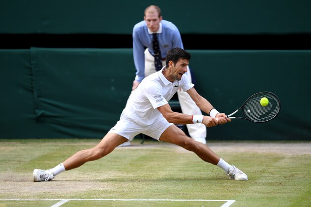 LONDON, ENGLAND - JULY 14: Novak Djokovic of Serbia plays a backhand in his Men's Singles final against Roger Federer of Switzerland during Day thirteen of The Championships - Wimbledon 2019 at All England Lawn Tennis and Croquet Club on July 14, 2019 in London, England. (Photo by Matthias Hangst/Getty Images)