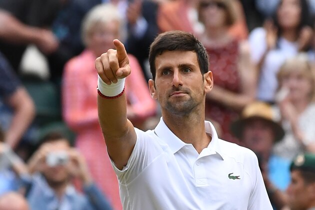 Serbia's Novak Djokovic celebrates beating Switzerland's Roger Federer during their men's singles final on day thirteen of the 2019 Wimbledon Championships at The All England Lawn Tennis Club in Wimbledon, southwest London, on July 14, 2019. (Photo by Ben STANSALL / AFP) / RESTRICTED TO EDITORIAL USE        (Photo credit should read BEN STANSALL/AFP/Getty Images)