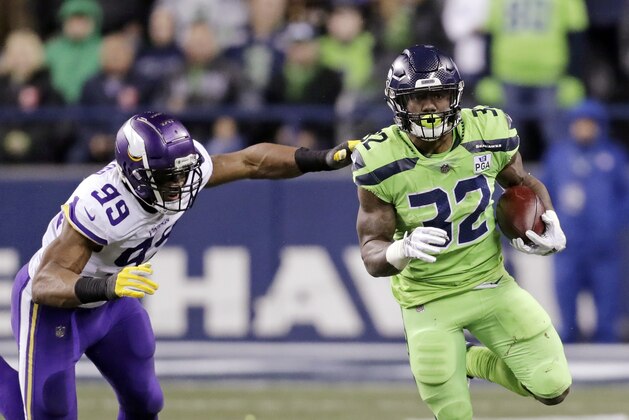 Seattle Seahawks' Chris Carson carries as Minnesota Vikings' Danielle Hunter gives chase in the first half of an NFL football game, Monday, Dec. 10, 2018, in Seattle. (AP Photo/Stephen Brashear)