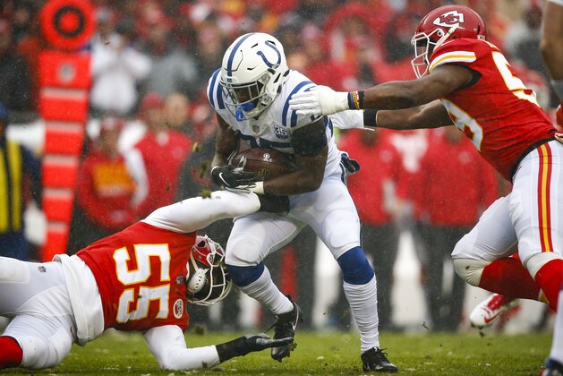 KANSAS CITY, MO - JANUARY 12: Running back Marlon Mack #25 of the Indianapolis Colts was tackled for a loss by outside linebacker Dee Ford #55 of the Kansas City Chiefs and inside linebacker Reggie Ragland #59 of the Kansas City Chiefs in the first quarter of the AFC Divisional Playoff at Arrowhead Stadium on January 12, 2019 in Kansas City, Missouri. (Photo by David Eulitt/Getty Images)