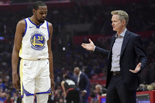 Golden State Warriors coach Steve Kerr, right, talks to forward Kevin Durant during the first half in Game 3 of the team's first-round NBA basketball playoff series against the Los Angeles Clippers on Thursday, April 18, 2019, in Los Angeles. (AP Photo/Mark J. Terrill)