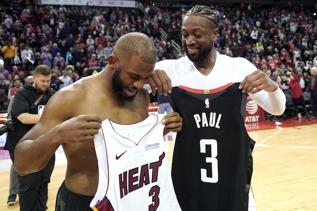 Houston Rockets' Chris Paul, left, exchanges jerseys with Miami Heat's Dwyane Wade after an NBA basketball game Thursday, Feb. 28, 2019, in Houston. The Rockets won 121-118. (AP Photo/David J. Phillip)