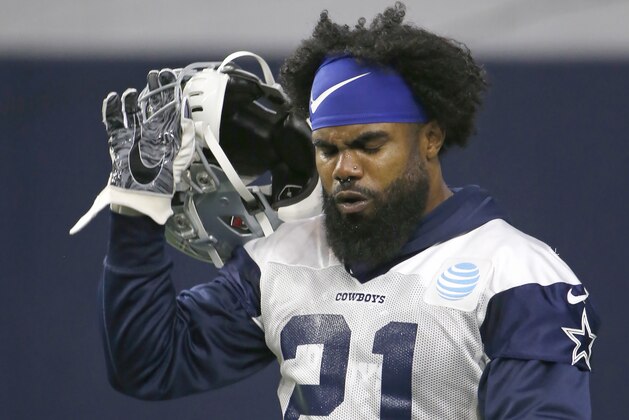 Dallas Cowboys running back Ezekiel Elliott (21) walks the field during an organized team activity at its NFL football training facility in Frisco, Texas, Wednesday, May 29, 2019. (AP Photo/Ron Jenkins)