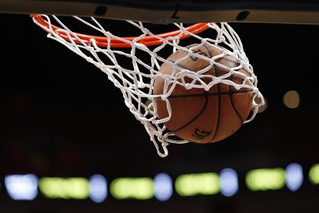A ball goes through the hoop as Miami Heat forward Kelly Olynyk warms up before the start of an NBA basketball game against the Washington Wizards, Friday, Jan. 4, 2019, in Miami. (AP Photo/Wilfredo Lee)