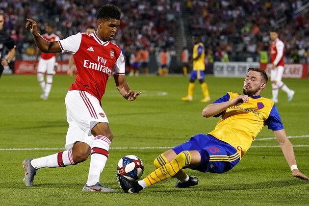 Colorado Rapids defender Sam Raben (18) slides in to try and steal the ball against Arsenal midfielder Gabriel Martinelli (35) during the second half of an international friendly soccer match, Monday, July 15, 2019, in Commerce City, Colo. (AP Photo/Jack Dempsey)