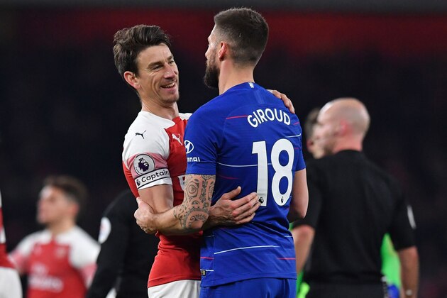 Arsenal's French defender Laurent Koscielny (L) and Chelsea's French striker Olivier Giroud chat on the pitch after the English Premier League football match between Arsenal and Cheslea at the Emirates Stadium in London on January 19, 2019. - Arsenal won the game 2-0. (Photo by Ben STANSALL / AFP) / RESTRICTED TO EDITORIAL USE. No use with unauthorized audio, video, data, fixture lists, club/league logos or 'live' services. Online in-match use limited to 120 images. An additional 40 images may be used in extra time. No video emulation. Social media in-match use limited to 120 images. An additional 40 images may be used in extra time. No use in betting publications, games or single club/league/player publications. /         (Photo credit should read BEN STANSALL/AFP/Getty Images)