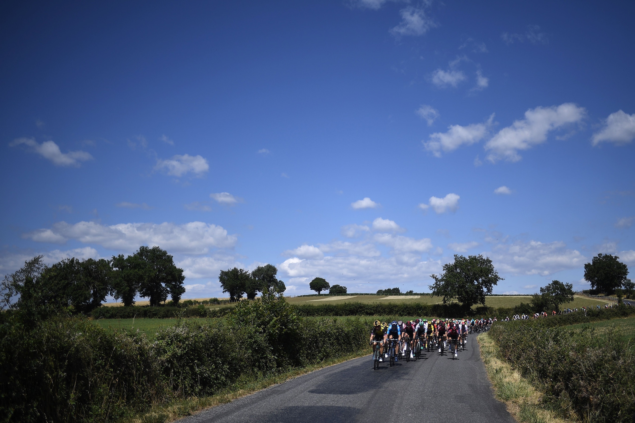 The pack rides in the countryside during the tenth stage of the 106th edition of the Tour de France cycling race between Saint-Flour and Albi, on July 15, 2019. (Photo by JEFF PACHOUD / AFP) (Photo credit should read JEFF PACHOUD/AFP/Getty Images) The pack rides in the countryside during the tenth stage of the 106th edition of the Tour de France cycling race between Saint-Flour and Albi, on July 15, 2019. (Photo by JEFF PACHOUD / AFP) (Photo credit should read JEFF PACHOUD/AFP/Getty Images)