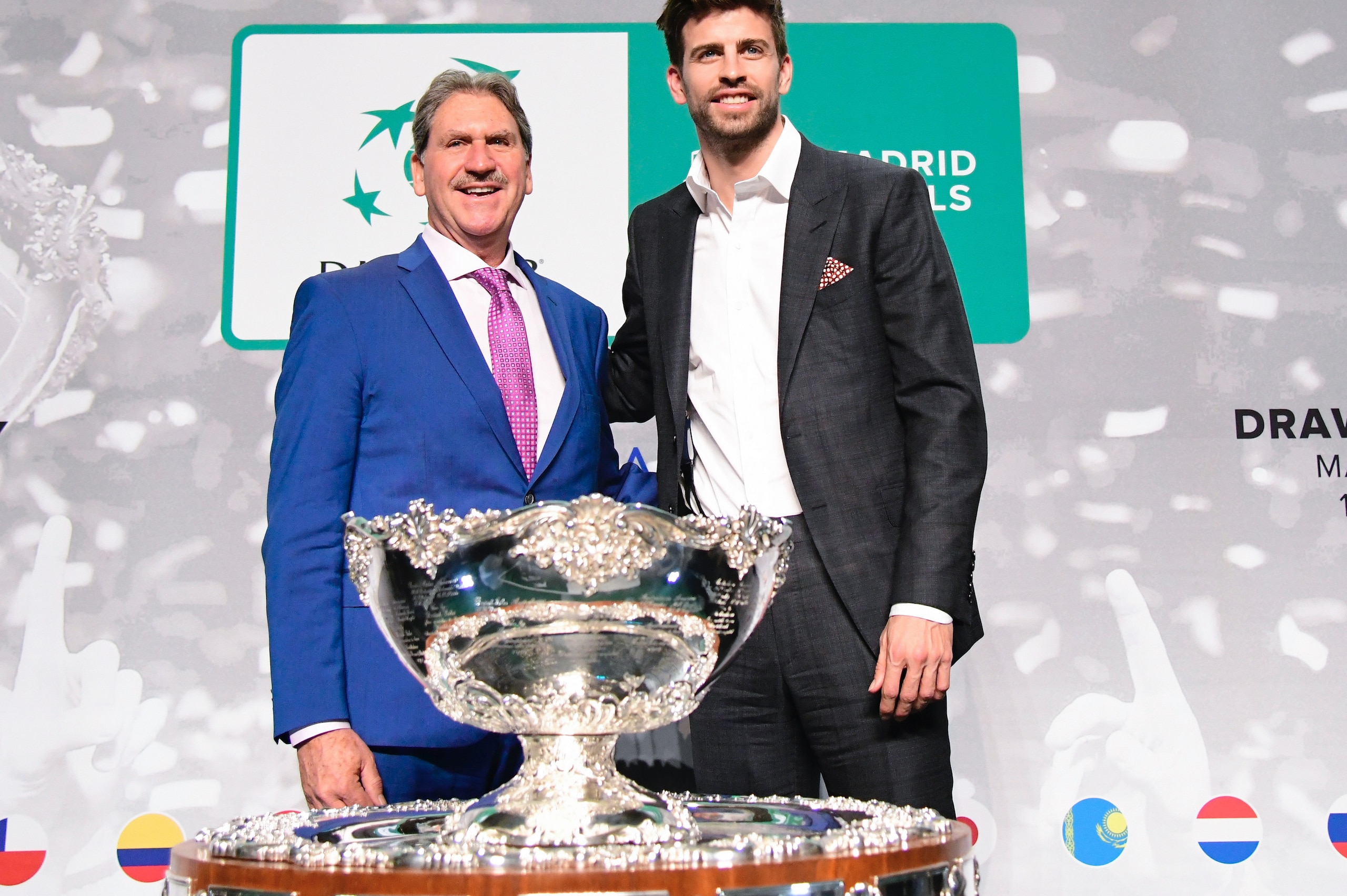 International Tennis Federation (ITF) president David Haggerty (L) and Barcelona's Spanish defender and Kosmos president Gerard Pique pose with the trophy after the draw for the 2019 Davis Cup tennis finals in Madrid on February 14, 2019. (Photo by JAVIER SORIANO / AFP)        (Photo credit should read JAVIER SORIANO/AFP/Getty Images)