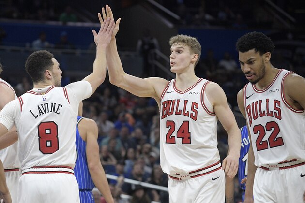 Chicago Bulls forward Lauri Markkanen (24) is congratulated by guard Zach LaVine (8) during the second half of an NBA basketball game against the Orlando Magic Friday, Feb. 22, 2019, in Orlando, Fla. (AP Photo/Phelan M. Ebenhack)