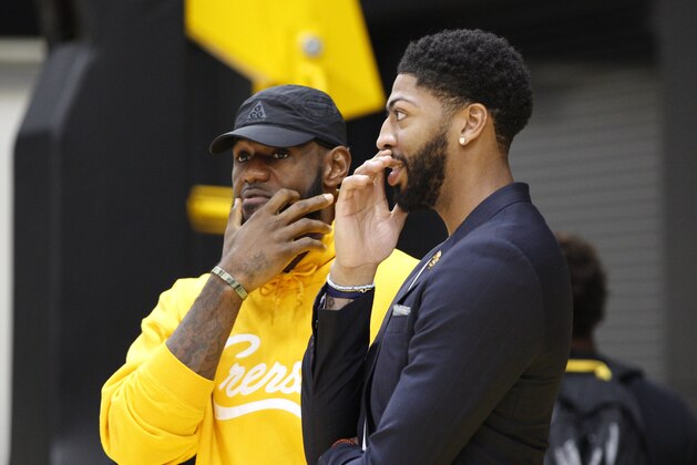 Los Angeles Lakers NBA basketball players, LeBron James, left, and Anthony Davis share a moment after David was introduced at a news conference at the UCLA Health Training Center in El Segundo, Calif., Saturday, July 13, 2019. (AP Photo/Damian Dovarganes)