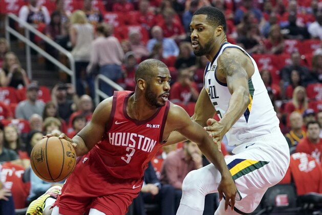 Houston Rockets guard Chris Paul (3) drives around Utah Jazz forward Derrick Favors (15) during the first half in Game 5 of an NBA basketball playoff series, in Houston, Wednesday, April 24, 2019. (AP Photo/David J. Phillip)