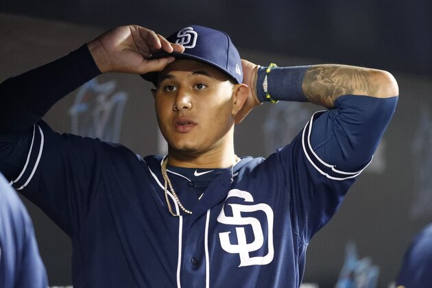 San Diego Padres' Manny Machado puts on his cap during the fourth inning a baseball game against the Miami Marlins, Tuesday, July 16, 2019, in Miami. (AP Photo/Wilfredo Lee)