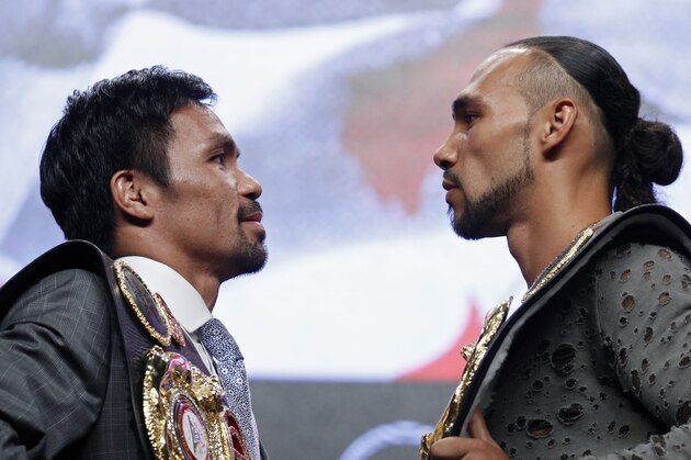 Manny Pacquiao, left, and Keith Thurman pose during a news conference Wednesday, July 17, 2019, in Las Vegas, for their welterweight championship boxing match scheduled for Saturday in Las Vegas. (AP Photo/John Locher)