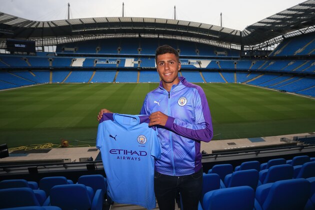 Manchester City's new signing Rodri displays his shirt at a press conference at the Etihad stadium in Manchester, northwest England on July 4, 2019. - Premier League champions Manchester City announced the signing of Spanish international midfielder Rodri on a five-year deal from Atletico Madrid for a club record fee. Rodri, 23, officially became a City player a day after the La Liga club revealed the 70-million-euro (£63 million) release clause in his contract had been triggered. (Photo by Lindsey Parnaby / AFP)        (Photo credit should read LINDSEY PARNABY/AFP/Getty Images)