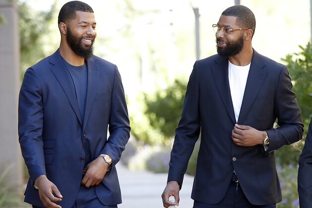 FILE in this Sept. 19, 2017 file photo, NBA players Markieff, left, and Marcus Morris arrive at Superior Court for the second day of their aggravated assault trial in Phoenix.  Jurors are expected to hear closing arguments Thursday, Sept. 28,  for the assault trial of the NBA players.  The Morris brothers are accused of helping three other people beat Erik Hood on Jan. 24, 2015. (AP Photo/Matt York, File)