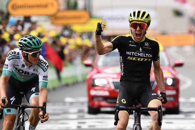 Great Britain's Simon Yates (R), past Austria's Gregor Muhlberger, celebrates as he wins on the finish line of the twelfth stage of the 106th edition of the Tour de France cycling race between Toulouse and Bagneres-de-Bigorre, in Bagneres-de-Bigorre on July 18, 2019. (Photo by Anne-Christine POUJOULAT / AFP)        (Photo credit should read ANNE-CHRISTINE POUJOULAT/AFP/Getty Images)