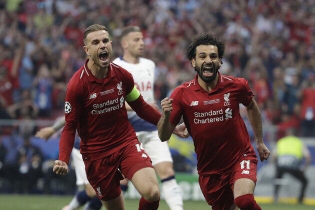 Liverpool's Mohamed Salah, right, celebrates after scoring his side's opening goal during the Champions League final soccer match between Tottenham Hotspur and Liverpool at the Wanda Metropolitano Stadium in Madrid, Saturday, June 1, 2019. (AP Photo/Felipe Dana)