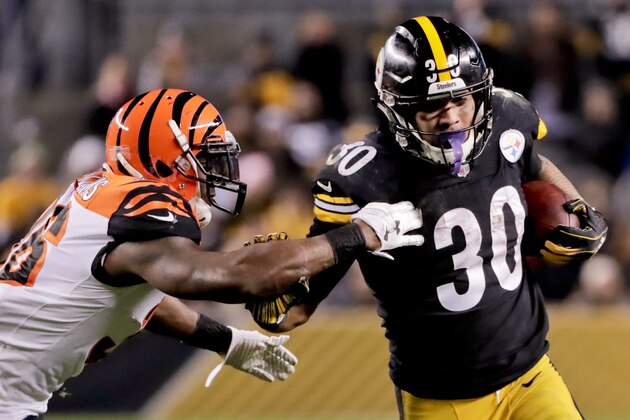 Pittsburgh Steelers running back James Conner (30) runs away from Cincinnati Bengals strong safety Shawn Williams (36) in the third quarter of an NFL football game against the Cincinnati Bengals, Sunday, Dec. 30, 2018, in Pittsburgh. Driskel recovered the fumble. (AP Photo/Gene J. Puskar)