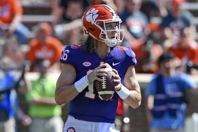 FILE - In this April 6, 2019, file photo, Clemson's Trevor Lawrence drops back to pass during Clemson's annual Orange and White NCAA college football spring scrimmage in Clemson, S.C. Clemson’s defense was a big reason why the Tigers won a second national championship in three seasons. Now that unit has massive holes to fill after losing its entire front to the NFL, along with three key linebackers and two members of the secondary _ and that could mean the Tigers have to win shootouts behind quarterback Trevor Lawrence to stay on top. (AP Photo/Richard Shiro, File)