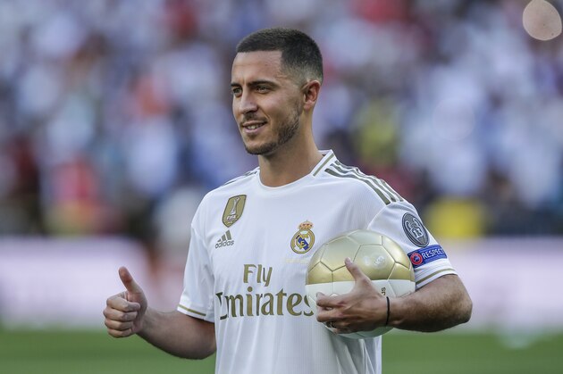 Belgium forward Eden Hazard poses for the media during his official presentation after signing for Real Madrid at the Santiago Bernabeu stadium in Madrid, Spain, Thursday, June 13, 2019. Real Madrid announced last week that it had acquired the 28-year-old Belgian playmaker from Chelsea for a reported fee of around 100 million euros ($113 million) plus variables, making him the club's most expensive signing ever. (AP Photo/Manu Fernandez)