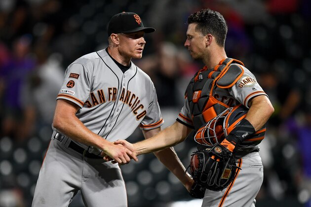 DENVER, CO - JULY 16:  Mark Melancon #41 and Buster Posey #28 of the San Francisco Giants celebrate an 8-4 win in 10 innings over the Colorado Rockies at Coors Field on July 16, 2019 in Denver, Colorado. (Photo by Dustin Bradford/Getty Images)