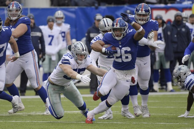 New York Giants' Saquon Barkley (26) runs the ball during the first half of an NFL football game against the Dallas Cowboys, Sunday, Dec., 30, 2018, in East Rutherford, N.J. (AP Photo/Bill Kostroun)