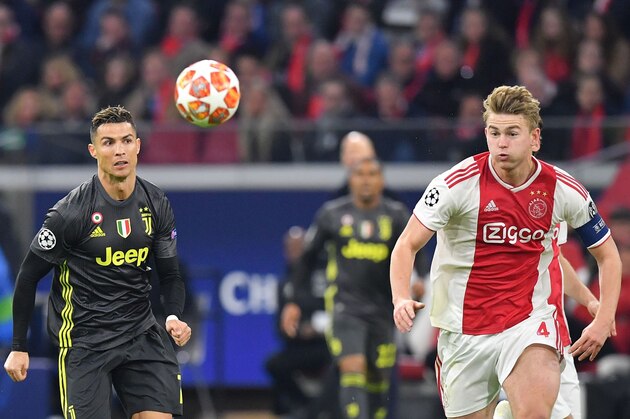 Juventus' Portuguese forward Cristiano Ronaldo (L) and Ajax's Dutch defender Matthijs de Ligt run for the ball  during the UEFA Champions League first leg quarter-final football match between Ajax Amsterdam and Juventus FC at the Johan Cruijff ArenA in Amsterdam on April 10, 2019. (Photo by EMMANUEL DUNAND / AFP)        (Photo credit should read EMMANUEL DUNAND/AFP/Getty Images)