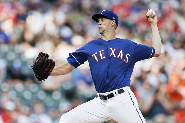 Texas Rangers starting pitcher Mike Minor throws during the first inning of a baseball game against the Houston Astros, Saturday, July 13, 2019, in Arlington, Texas. (AP Photo/Brandon Wade)