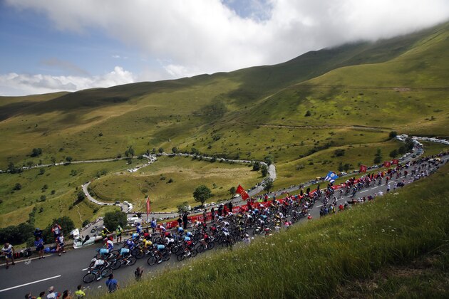 The pack rides during the twelfth stage of the Tour de France cycling race over 209,5 kilometers (130 miles) with start in Toulouse and finish in Bagneres-de-Bigorre, France, Thursday, July 18, 2019. (AP Photo/ Christophe Ena)