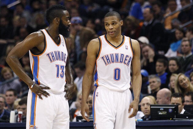 FILE - In this Jan. 25, 2012 file photo Oklahoma City Thunder guard James Harden, left, talks with teammate Russell Westbrook in the fourth quarter of an NBA basketball game in Oklahoma City. The Westbrook-Harden reunion in Houston is a neat story, but both guards have changes to make for the trade to work. They are both