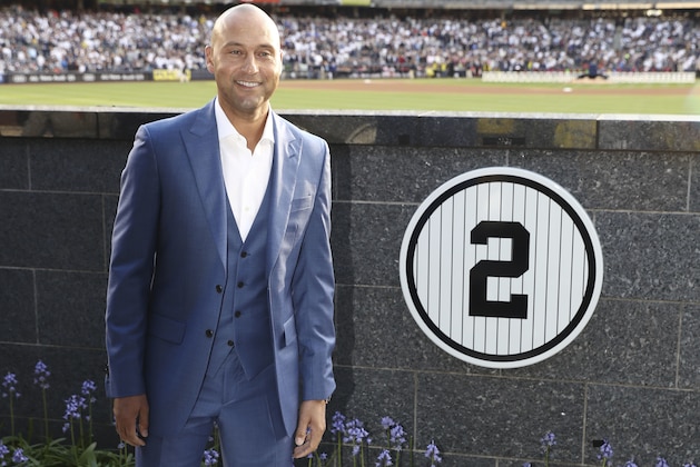 Former New York Yankee Derek Jeter poses for a picture with his number in Monument Park during a ceremony to retire his number at Yankee Stadium in New York, Sunday, May 14, 2017. (Elsa Garrison/Getty via AP, Pool)