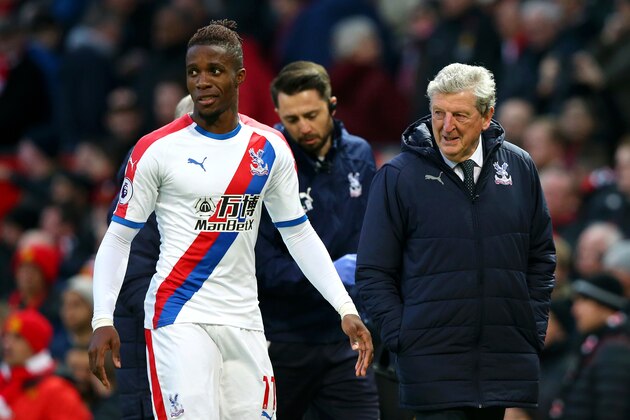 MANCHESTER, ENGLAND - NOVEMBER 24:  Wilfried Zaha of Crystal Palace speaks with Roy Hodgson, Manager of Crystal Palace following their sides draw in the Premier League match between Manchester United and Crystal Palace at Old Trafford on November 24, 2018 in Manchester, United Kingdom.  (Photo by Alex Livesey/Getty Images)