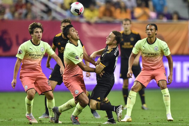 Manchester City's Rodri (2nd L) vies for the ball with Wolverhampton Wanderers' Diogo Jota (2nd R) during their final match of the 2019 Premier League Asia Trophy football tournament at the Hongkou Stadium in Shanghai on July 20, 2019. (Photo by HECTOR RETAMAL / AFP)        (Photo credit should read HECTOR RETAMAL/AFP/Getty Images)