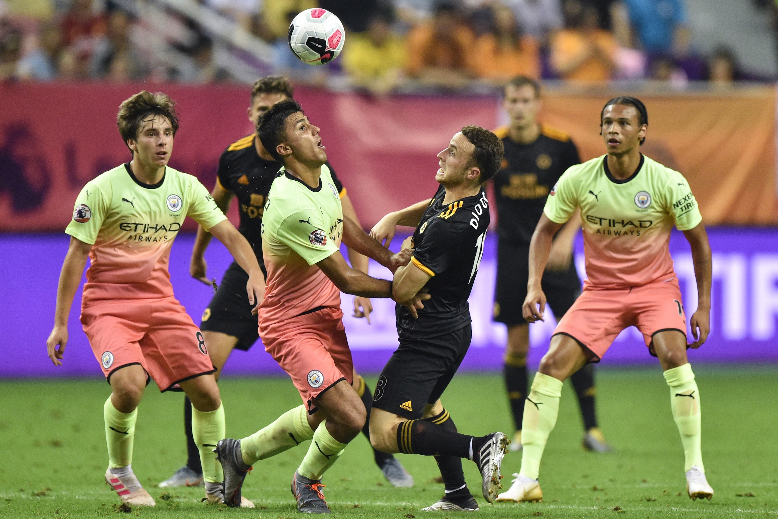 Manchester City's Rodri (2nd L) vies for the ball with Wolverhampton Wanderers' Diogo Jota (2nd R) during their final match of the 2019 Premier League Asia Trophy football tournament at the Hongkou Stadium in Shanghai on July 20, 2019. (Photo by HECTOR RETAMAL / AFP)        (Photo credit should read HECTOR RETAMAL/AFP/Getty Images)