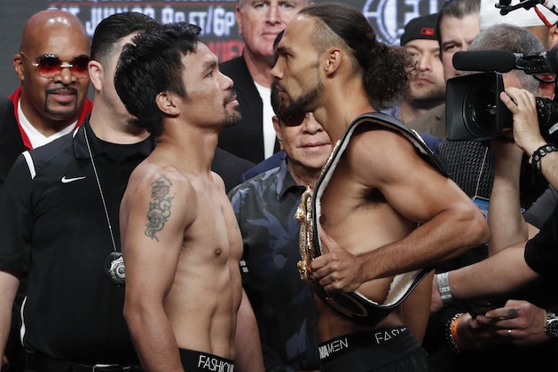 Manny Pacquiao, front left, and Keith Thurman pose during a weigh-in Friday, July 19, 2019, in Las Vegas. They are scheduled to fight in a welterweight championship boxing match Saturday in Las Vegas. (AP Photo/John Locher)