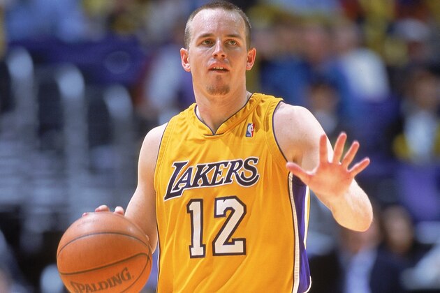 10 Dec 2000:  Mike Penberthy #12 of the Los Angeles Lakers signals as he dribbles the ball during the game against the Detroit Pistons at the STAPLES Center in Los Angeles, California. The Lakers defeated the Pistons 112-88.   NOTE TO USER: It is expressly understood that the only rights Allsport are offering to license in this Photograph are one-time, non-exclusive editorial rights. No advertising or commercial uses of any kind may be made of Allsport photos. User acknowledges that it is aware that Allsport is an editorial sports agency and that NO RELEASES OF ANY TYPE ARE OBTAINED from the subjects contained in the photographs.Mandatory Credit: Donald Miralle  /Allsport