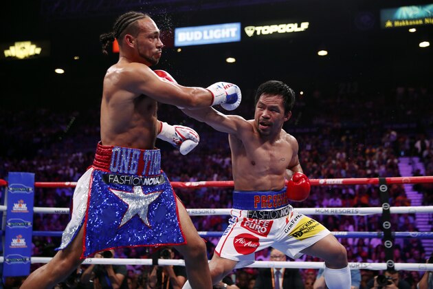 LAS VEGAS, NEVADA - JULY 20:  Manny Pacquiao (R) connects with a punch on Keith Thurman during their WBA welterweight title fight at MGM Grand Garden Arena on July 20, 2019 in Las Vegas, Nevada.  (Photo by Steve Marcus/Getty Images)