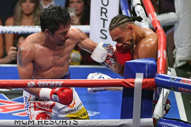 LAS VEGAS, NEVADA - JULY 20:  Manny Pacquiao (L) hits Keith Thurman in the fifth round of their WBA welterweight title fight at MGM Grand Garden Arena on July 20, 2019 in Las Vegas, Nevada. Pacquiao won in a split decision.  (Photo by Ethan Miller/Getty Images)