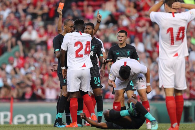 BOSTON, MA - JULY 21: Joris Gnagnon of Sevilla receives a red card after his tackle on Yasser Larouci of Liverpool during the pre-season friendly match between Sevilla and Liverpool at Fenway Park on July 21, 2019 in Boston, Massachusetts. (Photo by Matthew Ashton - AMA/Getty Images)