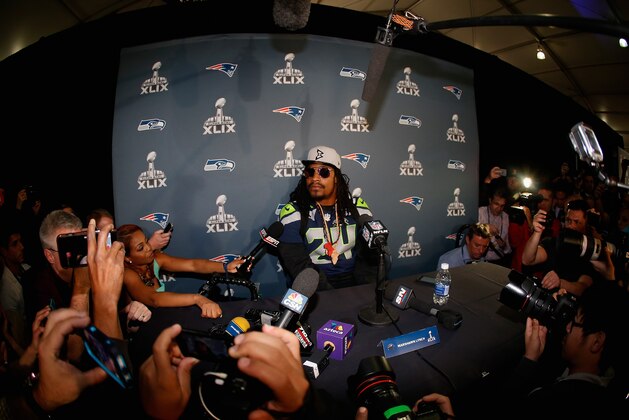 CHANDLER, AZ - JANUARY 28:  Running back Marshawn Lynch #24 of the Seattle Seahawks sits at his podium during a Super Bowl XLIX media availability at the Arizona Grand Hotel on January 28, 2015 in Chandler, Arizona.  (Photo by Christian Petersen/Getty Images)