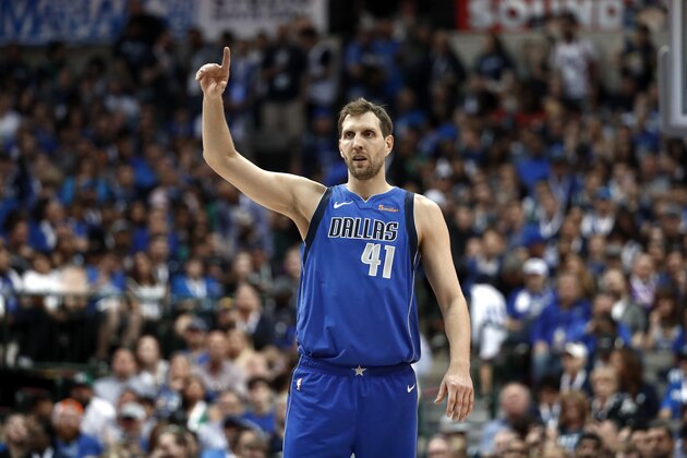 Dallas Mavericks' Dirk Nowitzki celebrates a teammate's basket during the second half of an NBA basketball game against the Phoenix Suns in Dallas, Tuesday, April 9, 2019. (AP Photo/Tony Gutierrez)