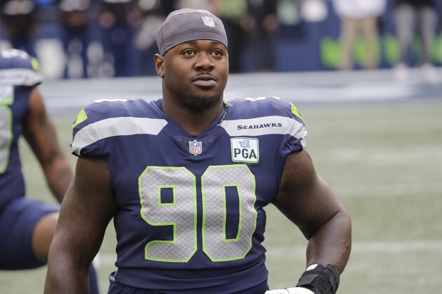 Seattle Seahawks defensive tackle Jarran Reed stretches before an NFL football game against the San Francisco 49ers, Sunday, Dec. 2, 2018, in Seattle. (AP Photo/Elaine Thompson)