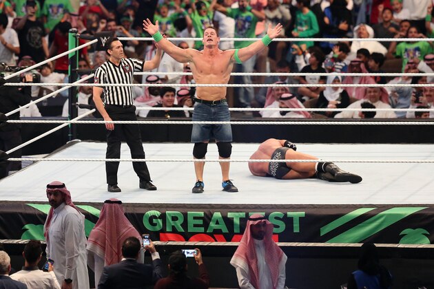 John Cena (C) celebrates defeating Triple H (R) during the World Wrestling Entertainment (WWE) Greatest Royal Rumble event in the Saudi coastal city of Jeddah on April 27, 2018. (Photo by STRINGER / AFP)        (Photo credit should read STRINGER/AFP/Getty Images)