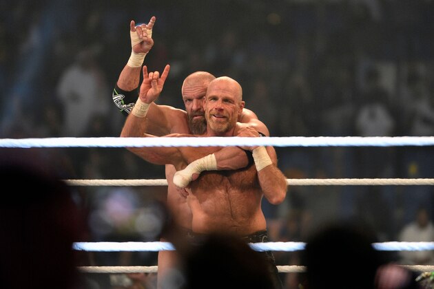 Shawn Michaels (R) and Triple H, of D-Generation X, celebrate their win during a tag team match as part of as part of the World Wrestling Entertainment (WWE) Crown Jewel pay-per-view at the King Saud University Stadium in Riyadh on November 2, 2018. (Photo by Fayez Nureldine / AFP)        (Photo credit should read FAYEZ NURELDINE/AFP/Getty Images)